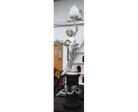 CANDLESTICK, of a putto silver painted on a black base, 120cm H.