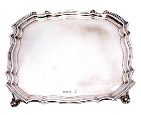 George VI waiter of shaped square design having "Chippendale" border and supported on four short scrolled feet, (uninscribed)