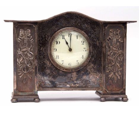 Decorative late 19th/early 20th century silver plated cased mantel clock with plain serpentine top, the front with circular d