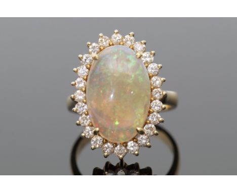 Opal and diamond dress ring, the oval shaped cabochon opal raised within a small diamond surround, all in a basket mount, sta