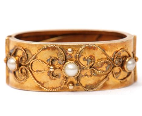 Victorian gold and seed pearl scarf clip, the front set with three small seed pearls raised within a filigree scroll design, 