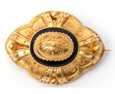 Victorian yellow gold and onyx target brooch, circa 1880, centred with a filigree decorated dome and raised within a black on