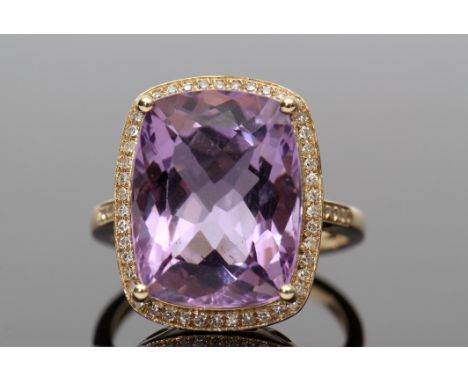 Amethyst and diamond ring, a cushion cut purple amethyst approx 9.40ct, set within a diamond surround, diamonds approx 0.30ct