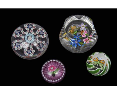 Group of paperweights including three Perthshire weights with multi-coloured designs and a Baccarat patterned millefiori weig