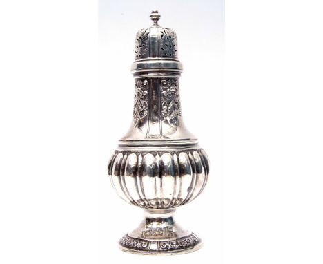 Large late Victorian sugar caster of circular baluster form with fluted and embossed body, urn finial to the domed lid, sprea