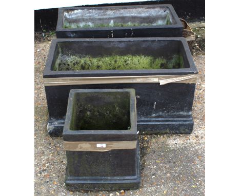 Pair of modern black painted garden planters of rectangular form on stepped bases, 74cm wide, together with Black painted com