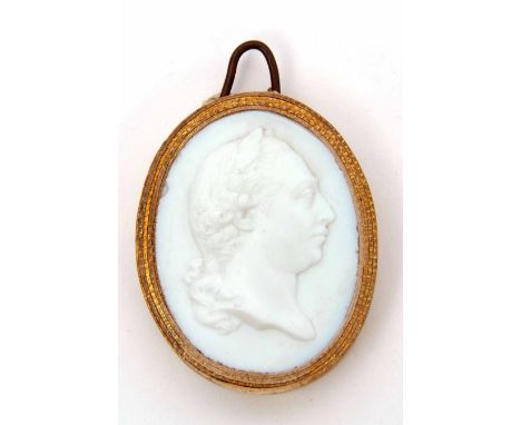 Georgian "Grand Tour" type milk glass cameo miniature of a gent, layered paper surround with wire hanger, 4cm x 3cm