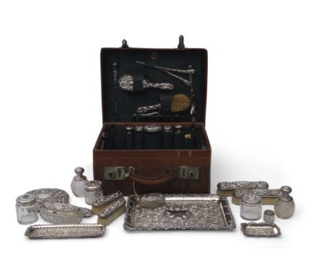 Edwardian leather travelling case with a majority of the original fittings including five silver topped bottles, glove stretc