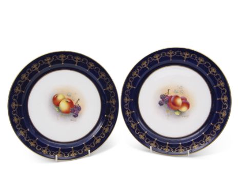 Pair of early 20th century Royal Worcester plates, the centres painted with fruit, by Townsend, the blue border with a gilt s