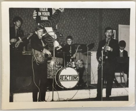 ROGER TAYLOR EARLY PHOTO. A 12.5 x 10cm original black and white photograph of a very young Roger Taylor playing drums with T