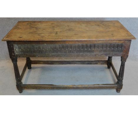 A 17th century oak console table with later top above carved frieze with turned stretchered supports. 69x126x58cm 