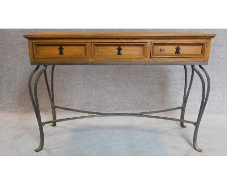 20th Century pitch pine console table with three drawers on cabriole wrought iron legs. 