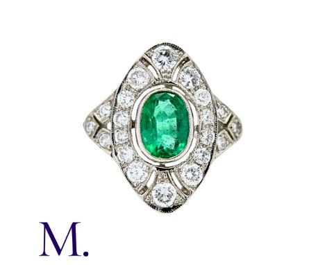 An Emerald and Diamond Ring in platinum, set with a principal oval cut emerald of approximately 1.10cts within a diamond set 