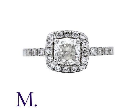 A 1.04ct Diamond Cluster Ring in platinum, set with a cushion cut diamond to the centre of 1.04cts with round cut diamonds in