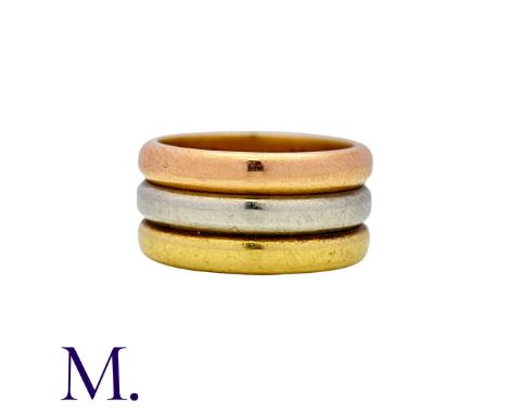 CARTIER. A Trinity Ring in 18K yellow, white and rose gold.  Signed Cartier London and marked 18ct. An earlier example.Size: 