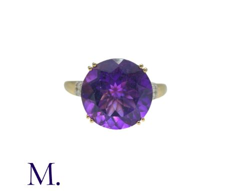 An Amethyst And Diamond Ring in 14k yellow gold, set with a principal round cut amethyst of approximately 7.50cts, with diamo