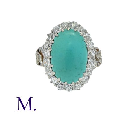 An Antique Turquoise and Diamond Cluster Ring in 18K yellow gold, set with an oval cabochon of turquoise with round cut diamo