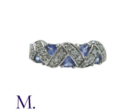 A Tanzanite And Diamond Ring in 9k white gold, set with trillion cut tanzanites and round cut diamonds. Stamped 9K, Hallmark 