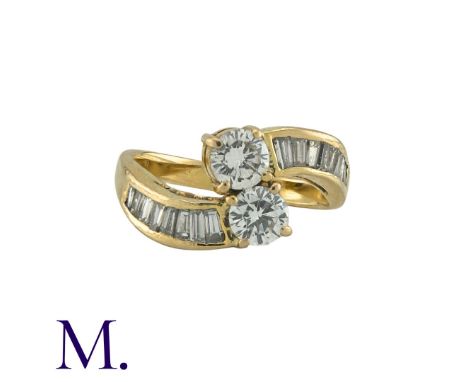 A Diamond Crossover Ring in 18K yellow gold, set with two round cut diamonds weighing approximately 0.60ct in total, together
