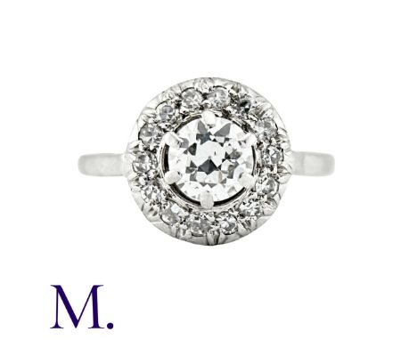 A Diamond Cluster Ring in 18K white gold set with a round cut diamond to the centre with fourteen further round cut diamonds 