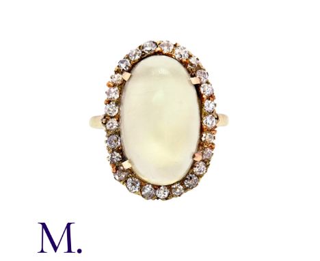A Moonstone and Diamond Ring in 9K yellow gold, set with a large cabochon moonstone (18x11mm) with 24 round cut diamonds in s