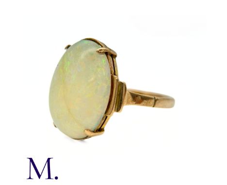 An Opal Ring in 9k yellow gold, set with a cabochon opal to stepped shoulders. Stamped 9ct.Size: J1/2Weight: 2.4g. 