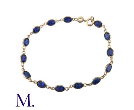 A Sapphire Bracelet in 9K yellow gold, with 14 spectacle-set oval-cut sapphires, each sapphire approximately 6x4mm.Size: 18.2