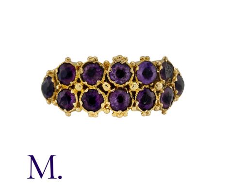 A Two-Row Amethyst Ring in yellow gold, set with twelve amethysts in two rows to an engraved band.  Unmarked but tests indica