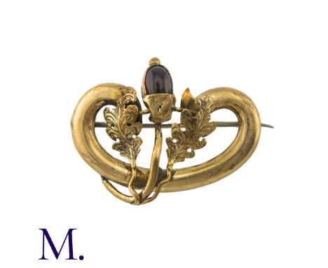 An Antique Garnet Brooch in 9K yellow gold.  Set with a cabochon garnet as an acorn between two oak leaves.  Unmarked but tes