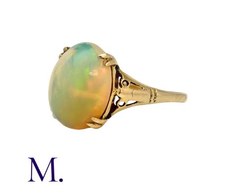 An Opal Ring in 9k yellow gold, set with a central cabochon opal of approximately 3.50cts. Stamped 9ct. Size: PWeight: 2.3g. 