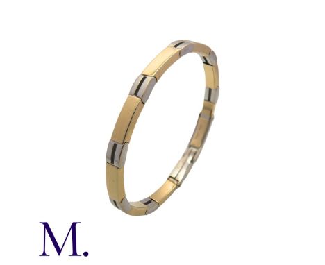 ROBERTO BRAVO. A 2-Colour Gold Bangle made up of alternating 14K white and yellow gold hinged links of 5mm width.  The clasp 