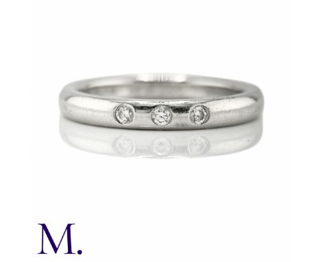 TIFFANY & CO. A Diamond Accent Ring in platinum, set with three round cut diamonds weighing approximately 0.10ct in total. Ba