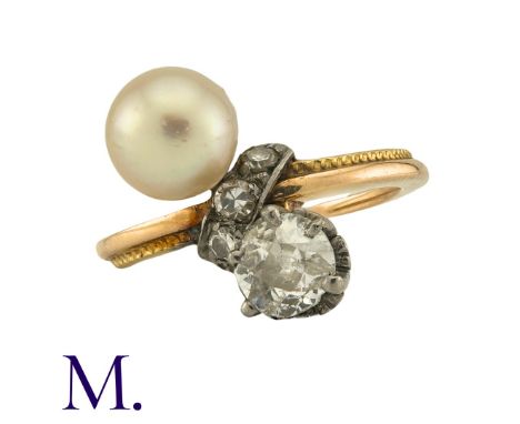 A Diamond And Pearl Toi Et Moi Ring in yellow gold, set with a principal old cut diamond of approximately 0.50cts, and a pear