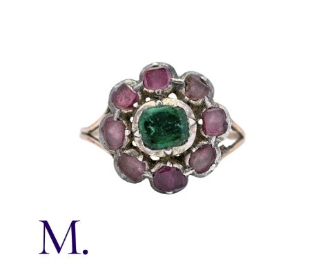 Antique Cluster Ring in yellow gold and silver set with green and red stones in closed back.  Unmarked but tests indicate 9 c