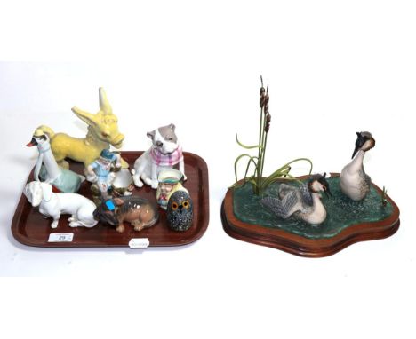 ^ A collection of 20th century figurines including: Lladro 'SeeSaw', Royal Doulton 'Pearly Boy', a model of a seated fox, Bes