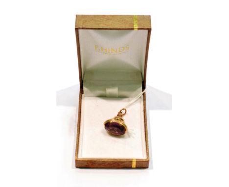 A 9 carat gold ornate amethyst fob.  Gross weight - 7.6 grams. 