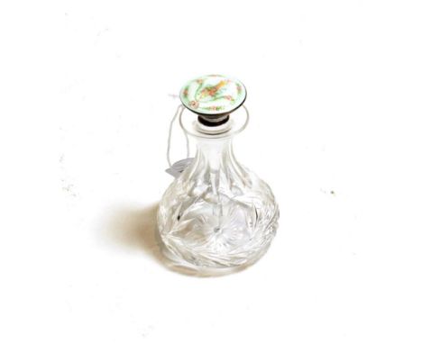 A cut glass pear shaped scent flask, with enamelled sterling silver stopper