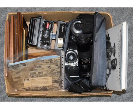 Assorted cameras and photographic accessories including Exakta, Carl Zeiss 50mm, 28mm and 300mm lenses, Polaroid, photos and 