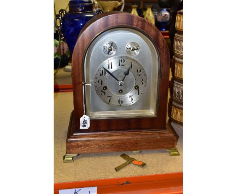 A TWENTIETH CENTURY JUNGHANS BRACKET CLOCK, the arched case supported on four brass feet, the silvered dial having black Arab