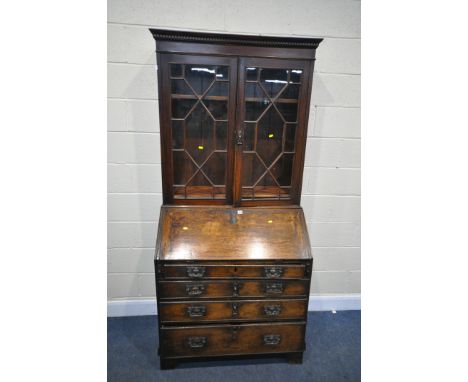 A GEORGIAN AND LATER OAK BUREAU BOOKCASE, the later top, enclosing three adjustable shelves, over a base with fall front and 