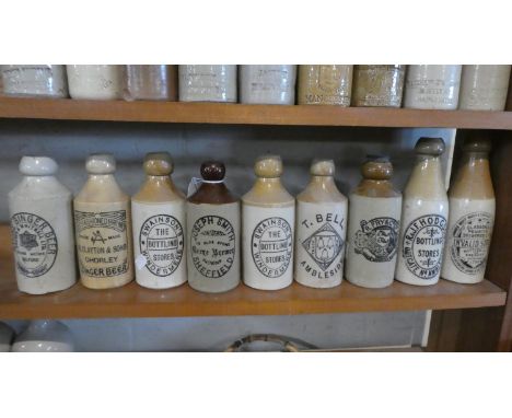 A Collection of Nine Stoneware Bottles with Printed Bottle for Stones Ginger Beer, R Clayton Chawley, Swainson's Windermere, 