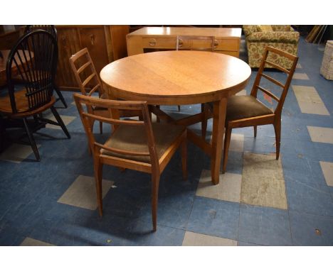 A 1970's Circular Oak Dining Table and Four Ladder Back Chairs 