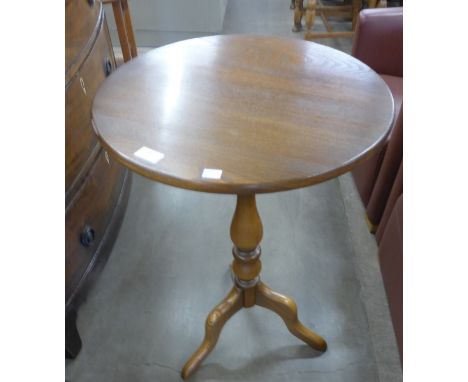 An Ercol Golden Dawn elm tripod table 