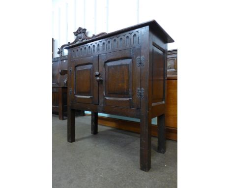 A 17th Century style carved oak two door credence cupboard 