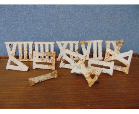 A set of cast iron clock Roman Numerals