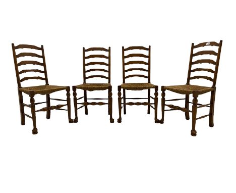 Four oak ladder back chairs with rush seats