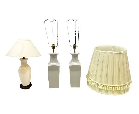 Pair of grey ceramic table lamps, together with another lamp on a wooden plinth and three lampshades