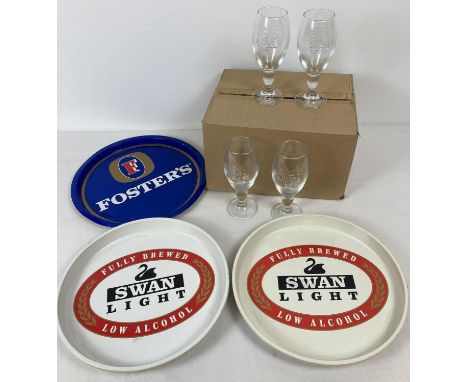 A collection of vintage brewery branded pub serving trays together with a box of 12 Stella Artois beer glasses. Trays include