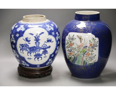 A Chinese Kangxi blue and white hundred antiques jar, 21cm, cracked, with hardwood stand and a Samson powder blue jar, 26cm, 