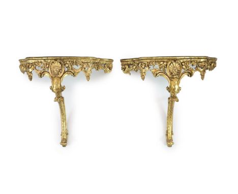 A pair of Louis XV style carved giltwood console tablesWith serpentine white marble tops, scroll and vine pierced freizes and
